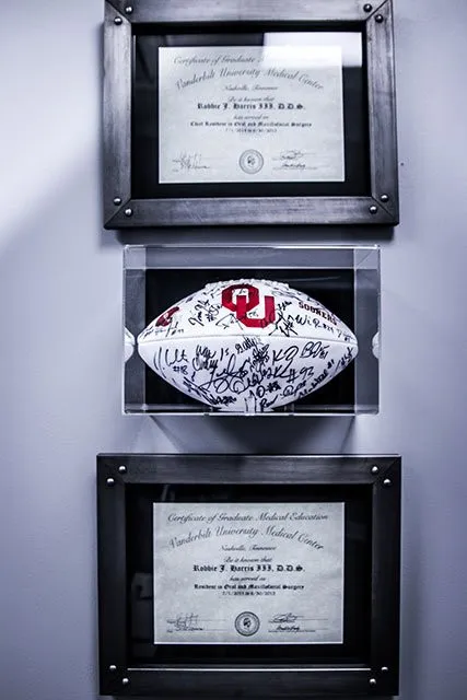 framed awards and diploma hanging on wall 